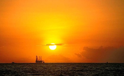 The Age Business 15th of June 2003,  Bayu-Undan gas field, Timor Sea.  Liquefied natural gas project; LNG;  platform; rig; brilliant sunset